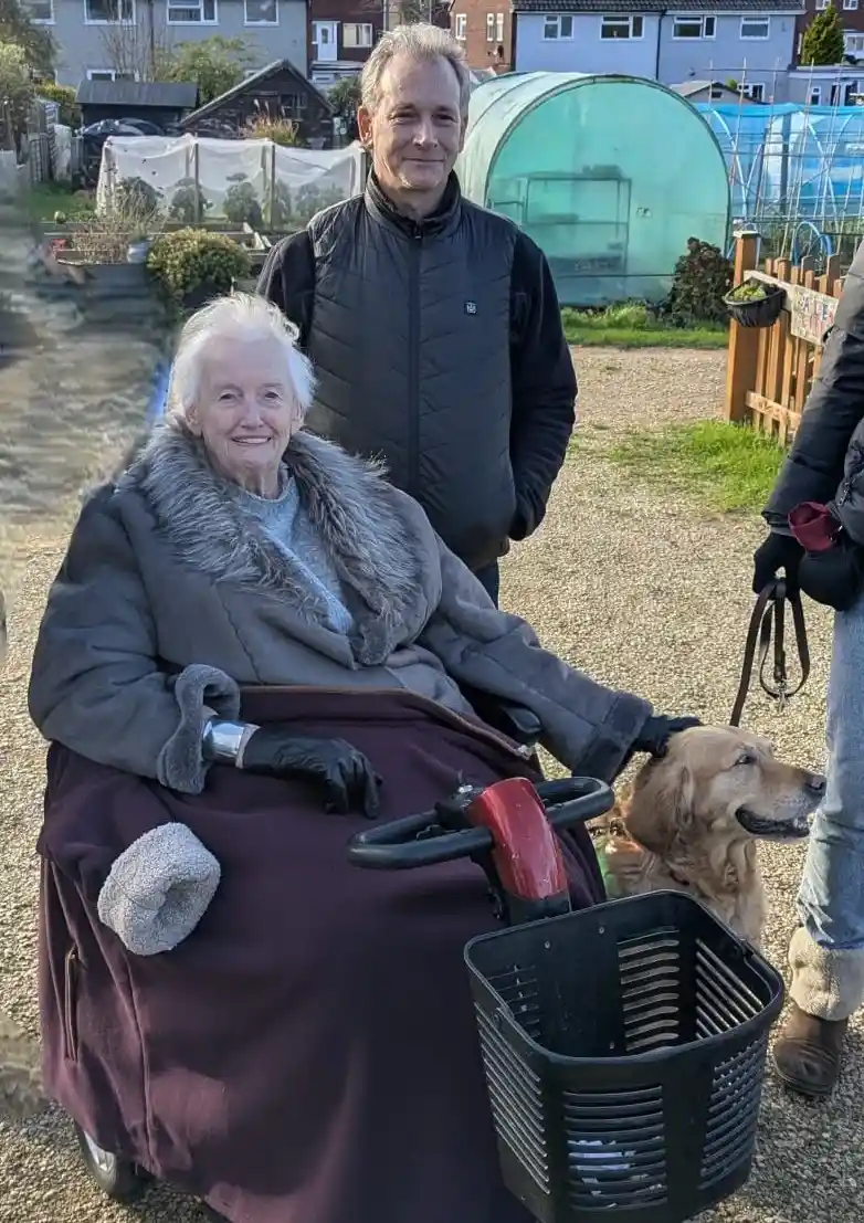 Carol, Paul, And Georgie Standing Together Outside Smiling