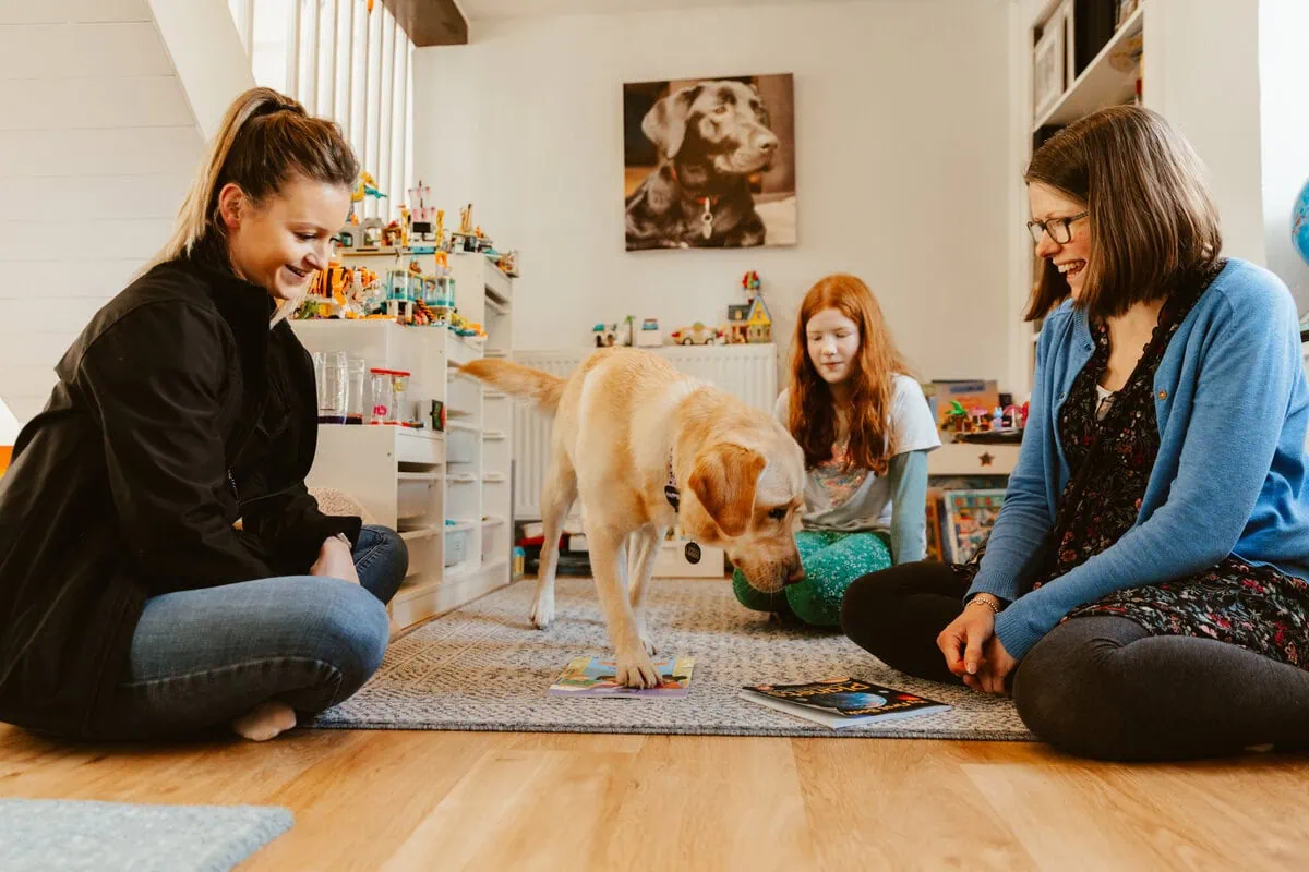 Yellow Labrador Training Trainer Parent Child Sitting Livingroom Sideview