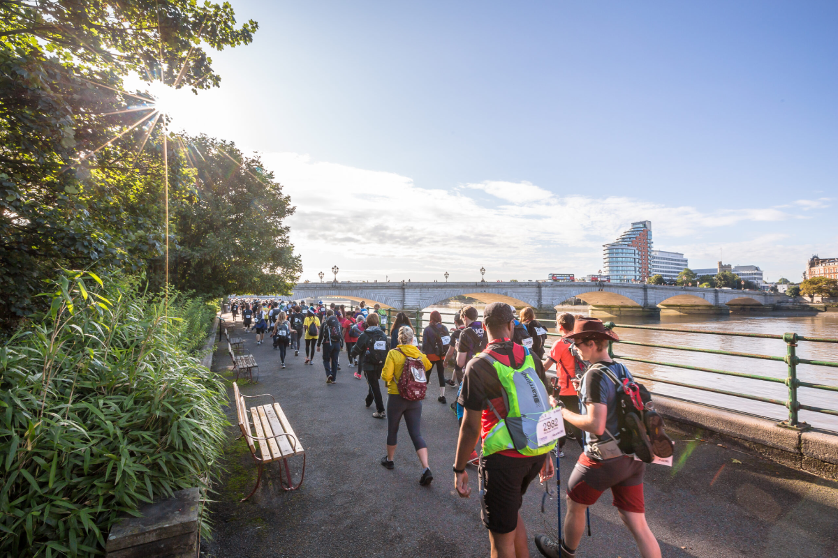Thames Path Ultra Challenge Participants Walking Alongside The River With City In The Background Scaled