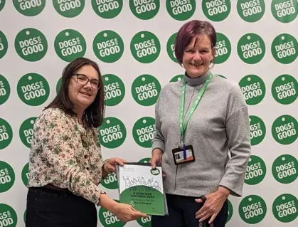 Volunteer Karen Duggan being handed award by our Trustee Ruth Goddard
