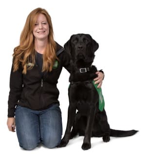 Trainer Leanne sat with Labrador cross golden retriever Harry