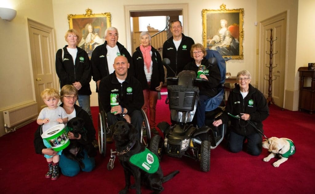 The Warwickshire supporter group with their fundraising buckets and their dogs