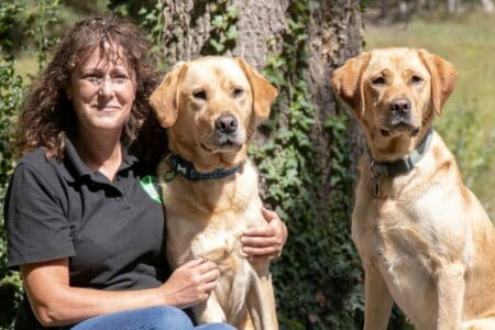 Lucy, community dog handler with dogs Lexi and Ned